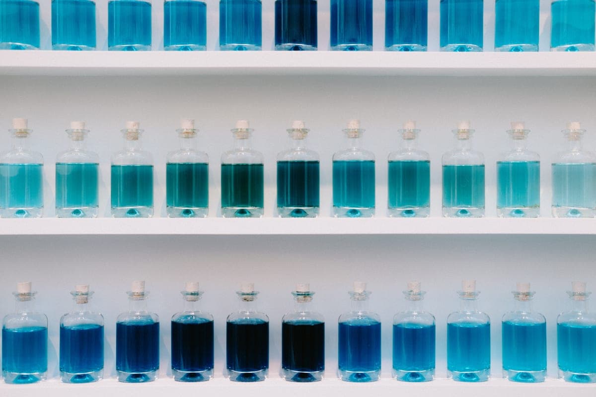 Bottles of water treatment chemicals lined up on a shelf