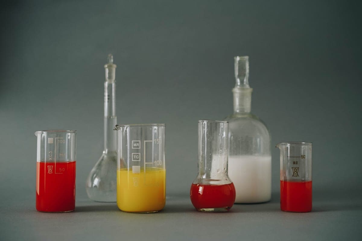 Two glass vessels of clear liquid side by side for comparison