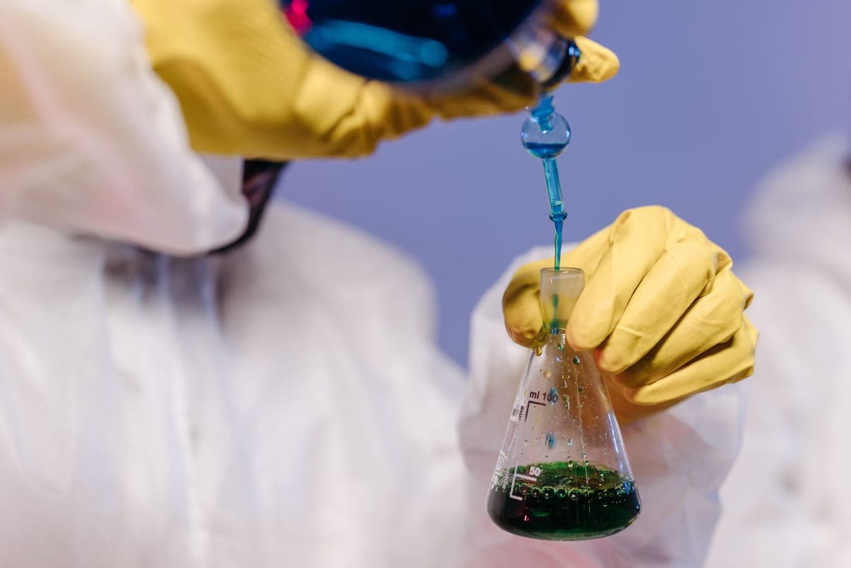 pH indicator paper being compared against a color scale