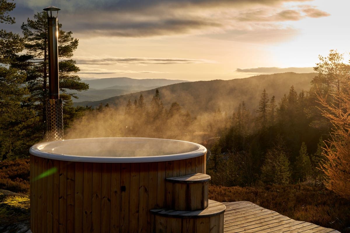 A covered hot tub on a deck under cool overcast light