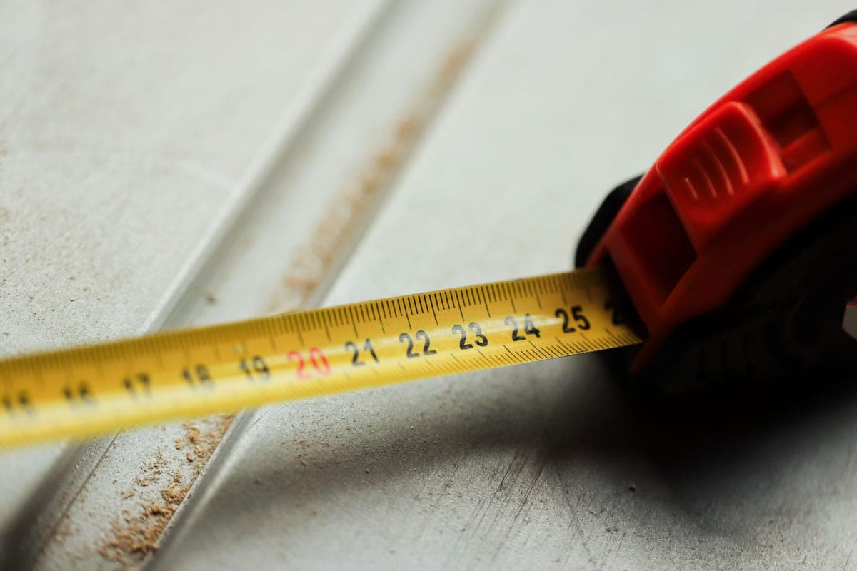A tape measure laid out across a timber surface