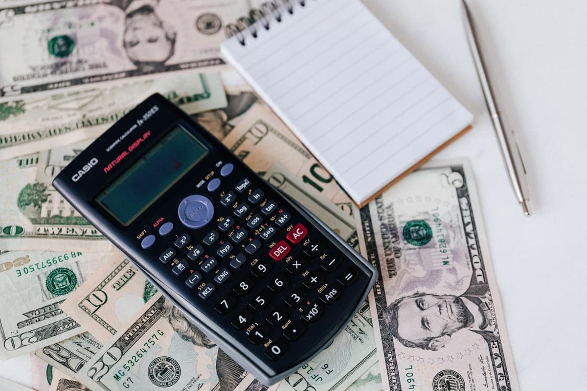 A calculator and notepad on a desk for working out figures